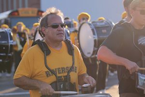 Alumni Band founder Mike Vaccariello marching into the stadium for the 2023 Homecoming game.